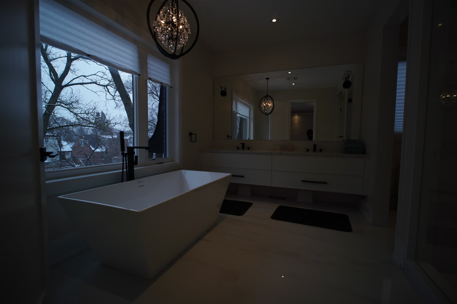 Dark exposure of a bathroom, the window view outside is visible